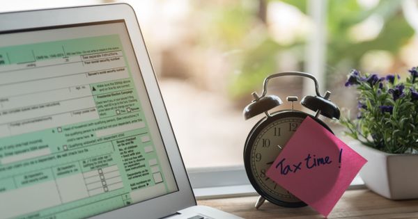 Desktop with Computer and Tax Time Note