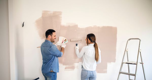 young couple redecorating a house