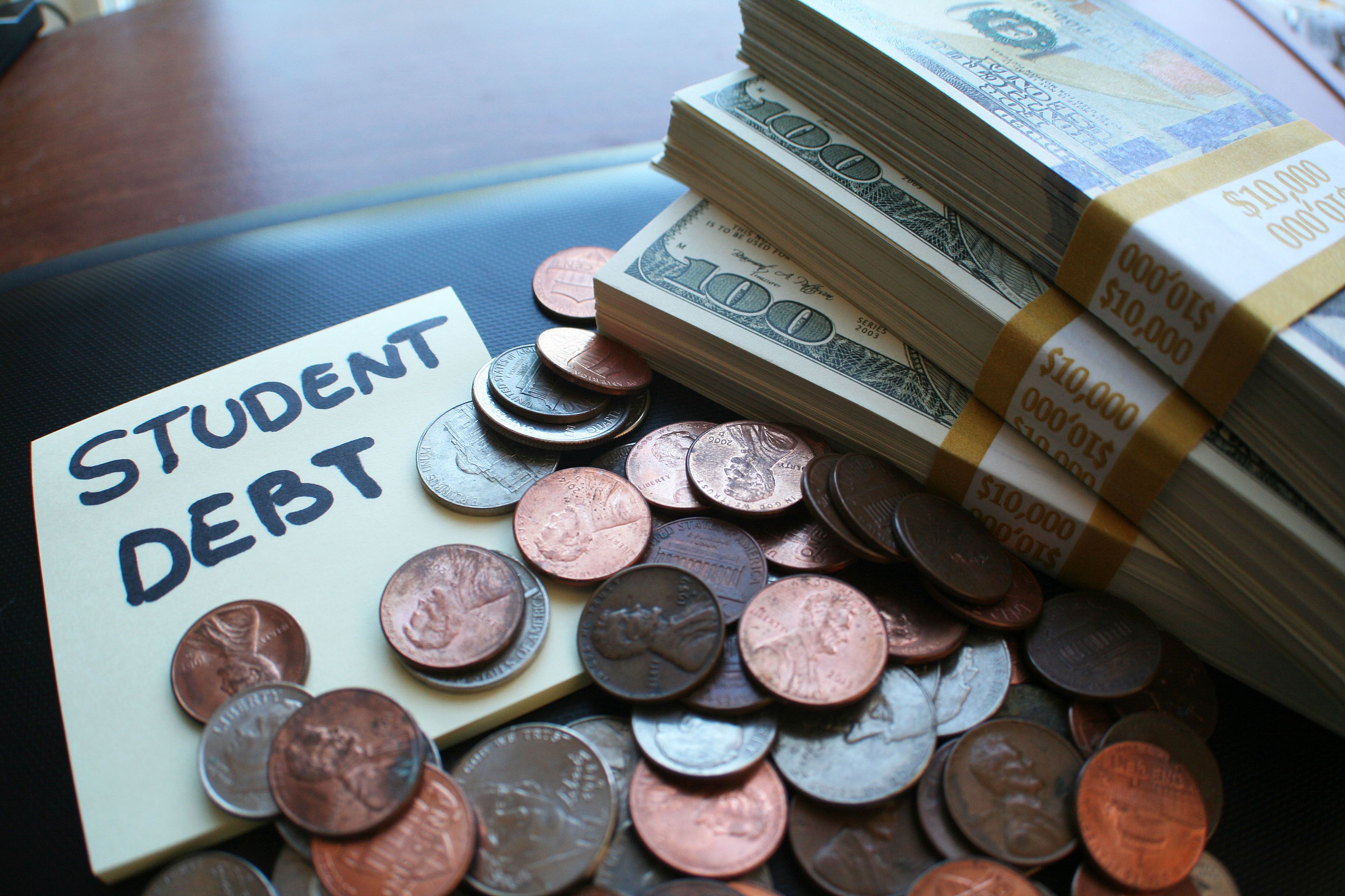 piles of cash representing student debt